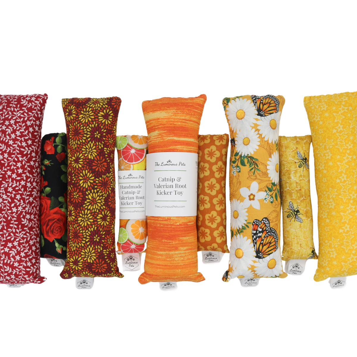 Collection of colorful catnip and valerian root kicker toys with labels on a white background | Handmade by The Luminous Pets