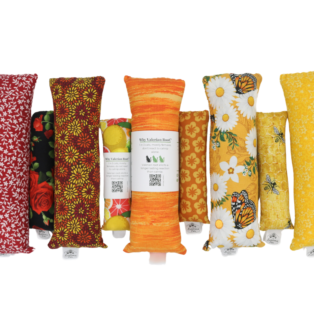 Collection of colorful catnip and valerian root kicker toys with labels on a white background | Handmade by The Luminous Pets
